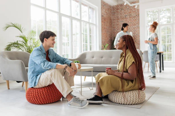 istock Diverse Friends Conversing in a Stylish Living Room 2203419643