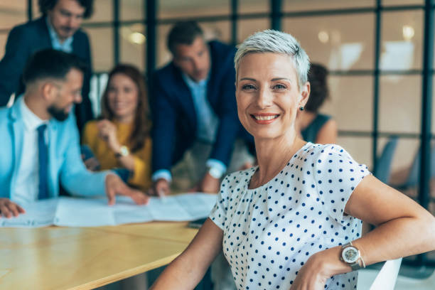 istock Confident businesswoman and her team 2203421630