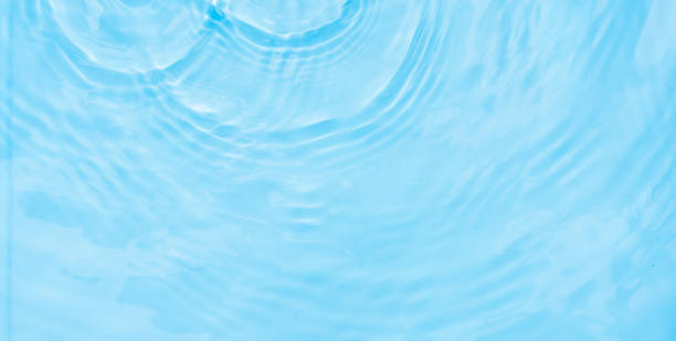 istock Water ripple surface, Summer backgrounds, Water waves abstract pattern texture on swimming pool,Top view poolside with light shadow on blue water 2203423101