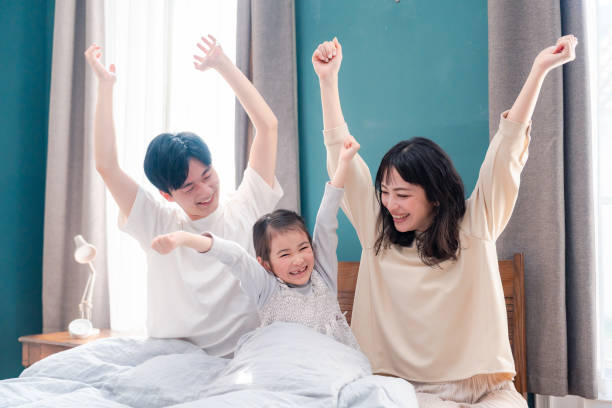 istock Families waking up well in bed 2203423487