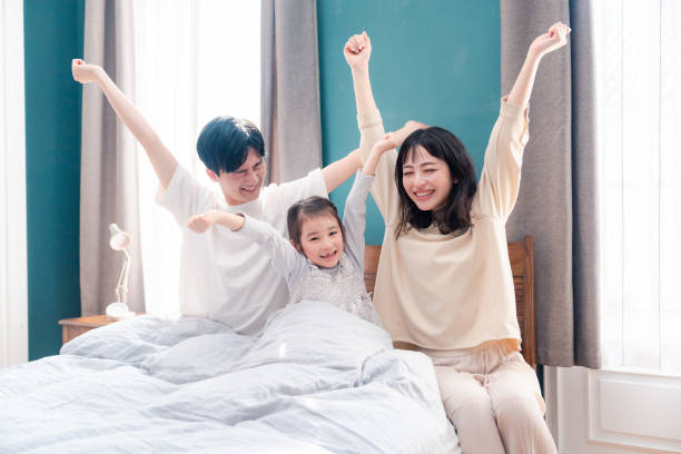istock Families waking up well in bed 2203423489