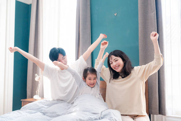 istock Families waking up well in bed 2203423494