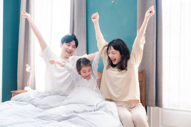 istock Families waking up well in bed 2203423495