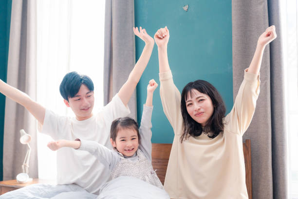 istock Families waking up well in bed 2203423496