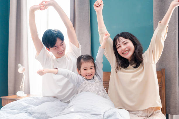 istock Families waking up well in bed 2203423503