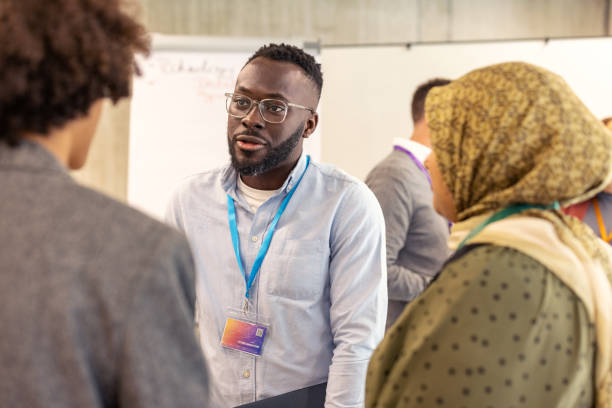 istock Business professionals engaging in networking session before corporate event 2203423661