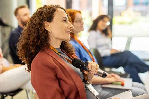 istock Businesswoman asking question during Q&A session at conference 2203423664