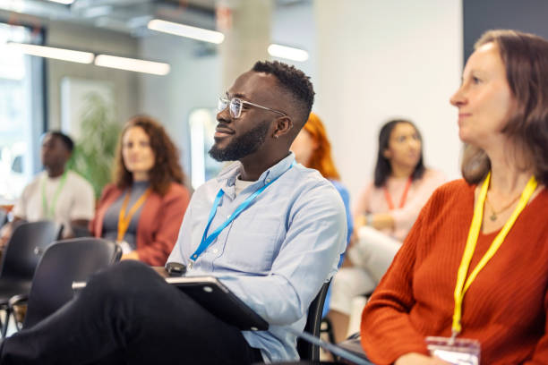 istock Multiracial business professionals attending seminar at convention center 2203423676