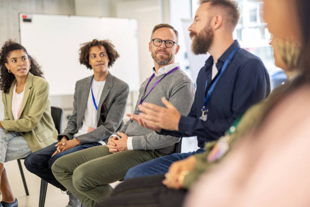 istock Businessman engaging in group discussion during office brainstorming session 2203423683