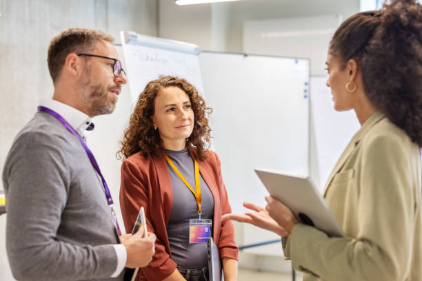 istock Diverse team interacting before corporate presentation at convention hall 2203423688