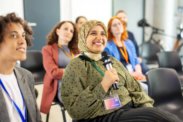 istock Middle Eastern entrepreneur engaging in seminar with questions to presenter 2203423696