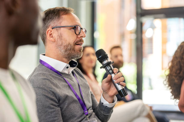 istock Mature businessman participating with questions during seminar event 2203423702