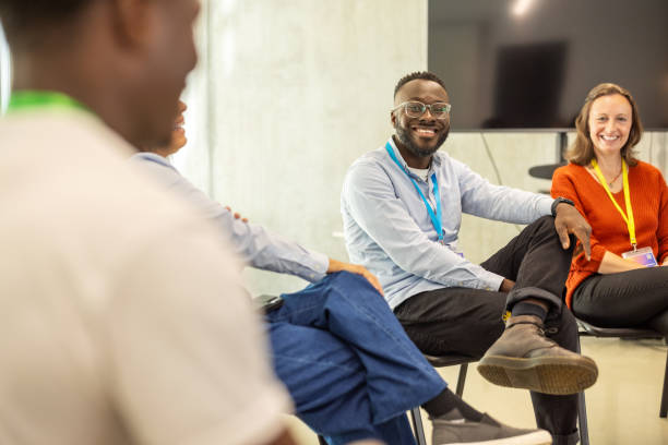 istock Happy professionals having a brainstorming session at a corporate conference 2203423738