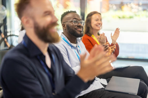istock Entrepreneurs clapping in audience after successful seminar event 2203423740