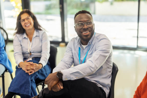 istock Happy business professionals engaged in brainstorming session at conference 2203423746