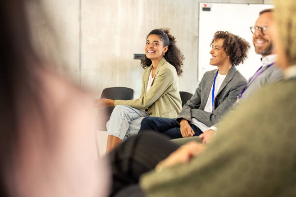istock Businesspeople collaborating in group discussion during corporate seminar 2203423753