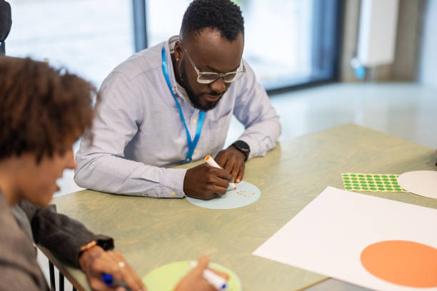 istock Businessman participating in activities during a seminar at convention center 2203423755