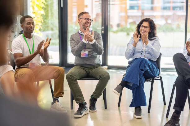 istock Team celebrating success with applause during office staff meeting 2203423777