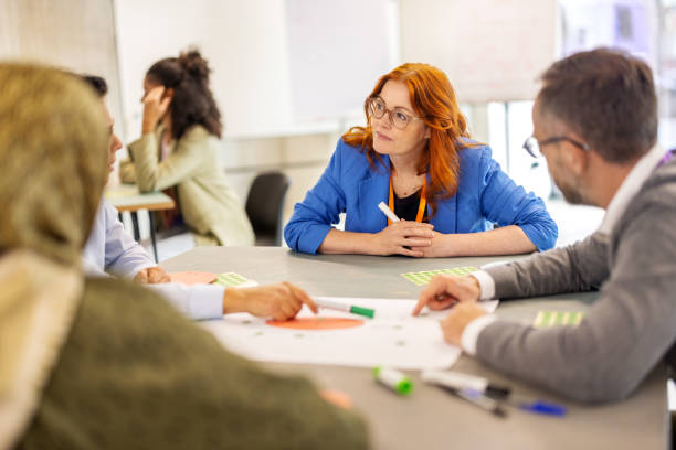 istock Diverse business professionals collaborating in peer-to-peer seminar activities 2203423787