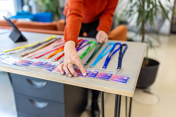 Event organizer preparing ID cards for participants at reception desk