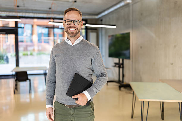 istock Professional businessman standing in an office at a convention center 2203423943