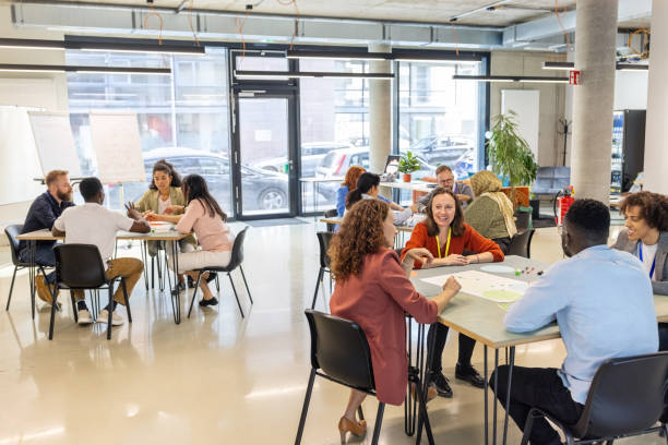 istock Diverse professionals collaborating in small groups during seminar 2203423999