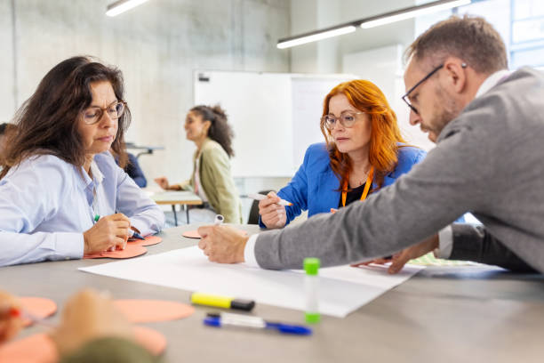 Multiracial professionals engaging in activities during seminar