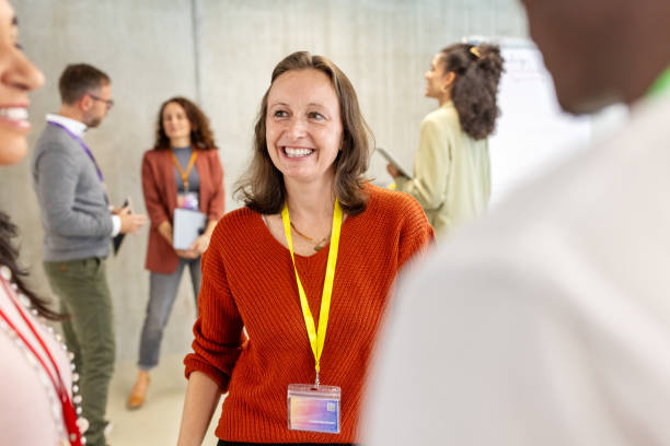 istock Conference attendees networking and discussing before the commencement of a business seminar 2203424054