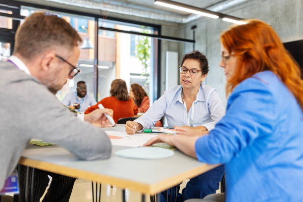 istock Group of diverse business people actively engaging in seminar activities 2203424076