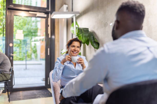 istock Two business people having conversations at coffee shop during a break 2203424119