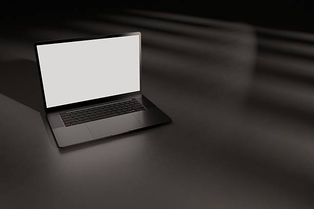istock Mockup laptop on dark floor, hit by sunlight 2203424250
