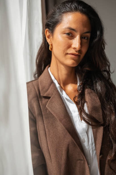 istock Confident woman posing in elegant blazer under natural soft lighting 2203424668