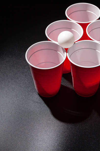 istock Beer pong college game on black background 2203425707