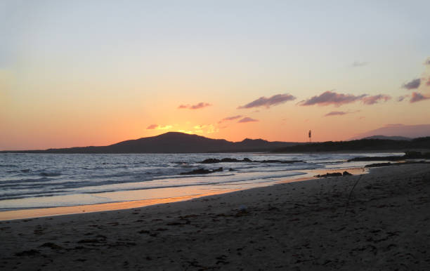 scenic sunset at the Galapagos islands at Isabela with bright sun behind the mountain