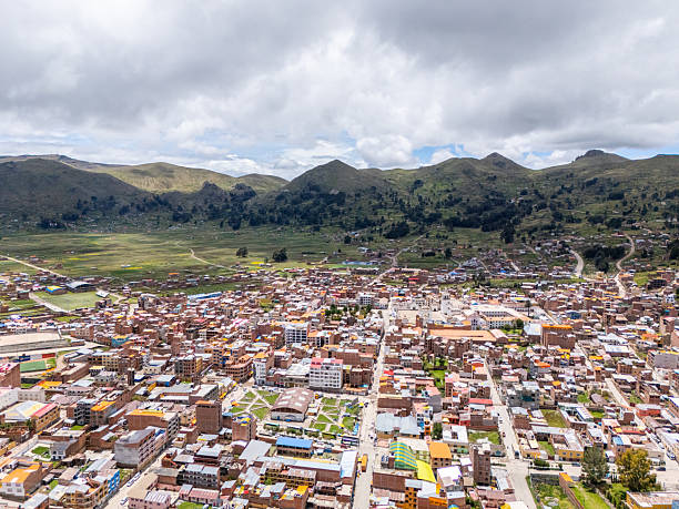 Vibrant town with colorful buildings surrounded by mountains. Stunning aerial perspective of urban and natural landscape.