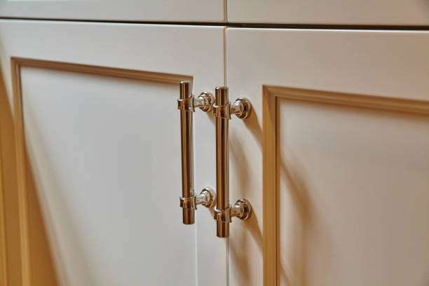 istock Elegant Cabinet Latch Detail on Cream Doors - Close-Up View 2203431143