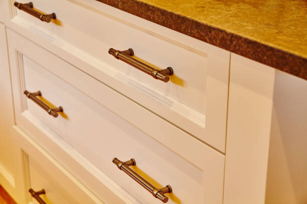istock Modern White Kitchen Drawers with Bronze Handles and Stone Countertop - Eye Level 2203431194