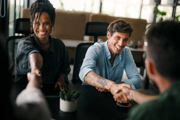 istock Diverse group of business people's hands showing unity and teamwork. Diverse hands for teamwork 2203432323