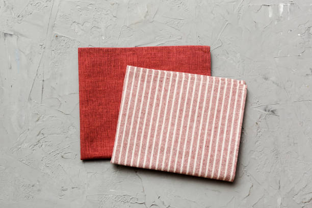 istock top view with red empty kitchen napkin isolated on table background. Folded cloth for mockup with copy space, Flat lay. Minimal style 2203432953