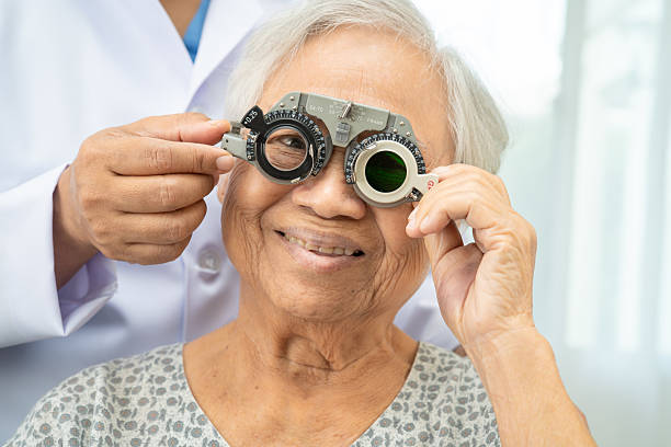 istock Asian senior woman wearing ophthalmic vision eye test and using optical trial frame. 2203434004