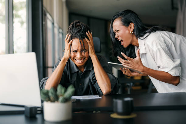 istock Boss shouting at frustrated worker, bullying and emotional abuse at work. Stressful work environment 2203434025