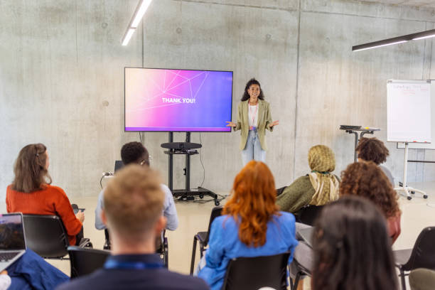 istock Entrepreneur standing by display screen and talking during business conference 2203435066