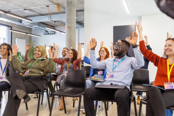istock Diverse professionals celebrating achievement with sign language applause 2203435137