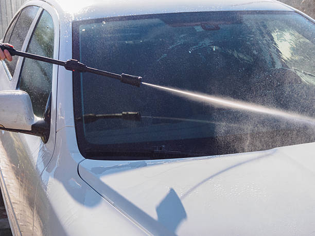 Manual car high-pressure wash using equipment for effective dirt removal and coating protection.