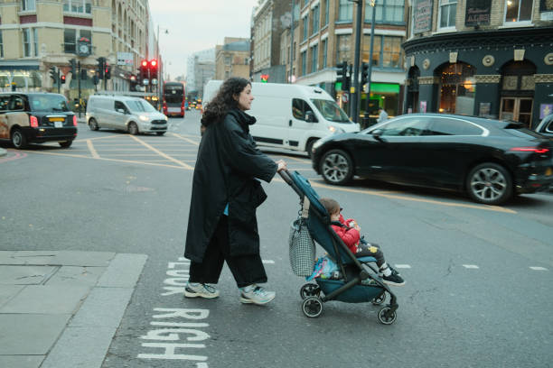 istock Mother pushing stroller across London street 2203440103