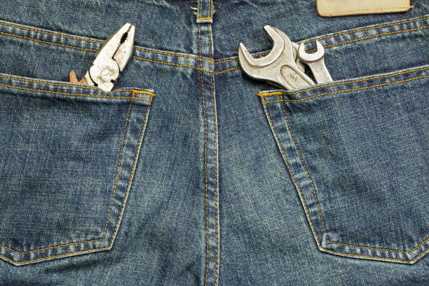 Tools stuffed into the back pocket of jeans