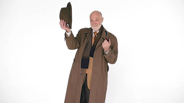 istock Elegant elderly man with a Smoking pipe takes off his hat on a white background 2203441110