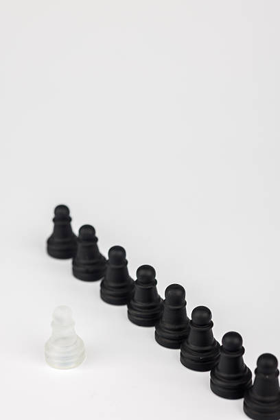A visually striking chess image of a lone white pawn against black pawns. The fallen king highlights the themes of strategy, sacrifice, and leadership