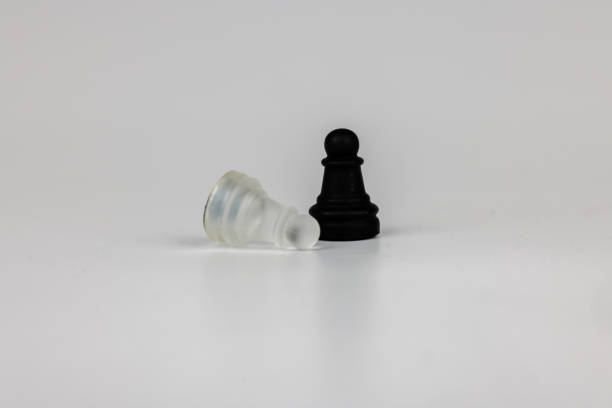 istock Transparent black and white pawns on a clean white background, symbolizing board game strategy, rivalry, and tactical challenges 2203443955