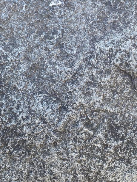 istock Natural Stone Floor Background: Weathered Rock Masonry, Rustic Stone Paving, Organic Granite and Slate Texture, Timeless, Rugged Surface with Detailed Cracks and Natural Variations, Ideal for Architectural Renders, Digital Art, and Creative Design 2203444465